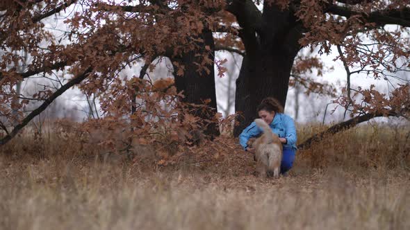 Smiling Woman and Dog During Training Outdoors