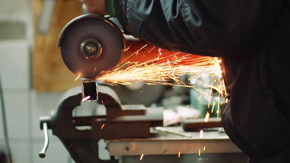 Angle Grinder Cutting Metal at Workshop