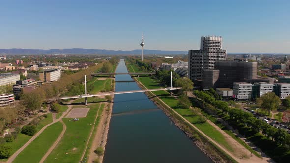 Top view of the embankment of the Neckar River. Bridges, TV tower, green grass.