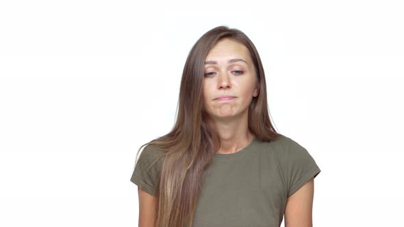 Caucasian Blueeyed Girl Shrugging Expressing Hesitation with Pursed Lips Over White Background