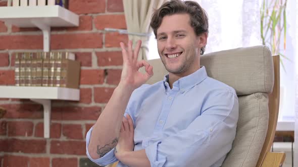 Cheerful Young Man Showing Ok Sign