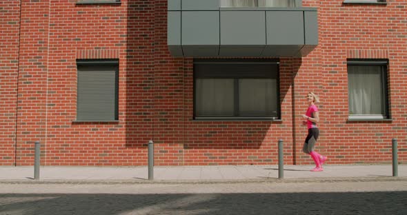 Young Woman Jogging in the City Doing Sports in the Morning