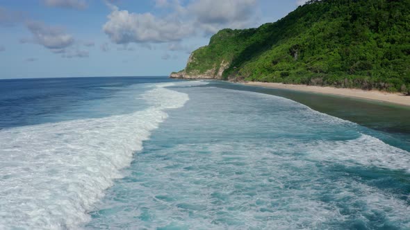 Aerial View of Ocean with Beautiful Foaming Rolling Waves, Mountain on Beach