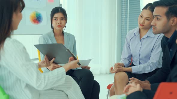 Business People Proficiently Discuss Work Project While Sitting in Circle
