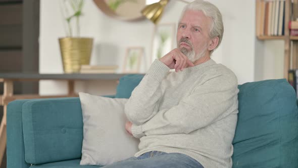 Old Man Thinking While Sitting on Sofa