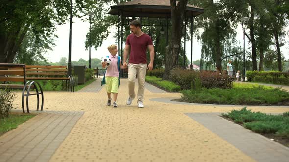 Father Taking Son to Sport Classes, Boy Holding Ball and Talking With Dad