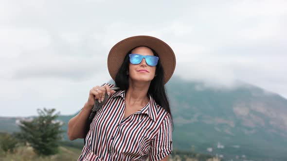 Happy Elegant Tourist Woman with Backpack Admiring Amazing Nature Scenery From Mountain Peak