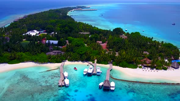 Aerial drone scenery of tourist beach by blue ocean with sand background