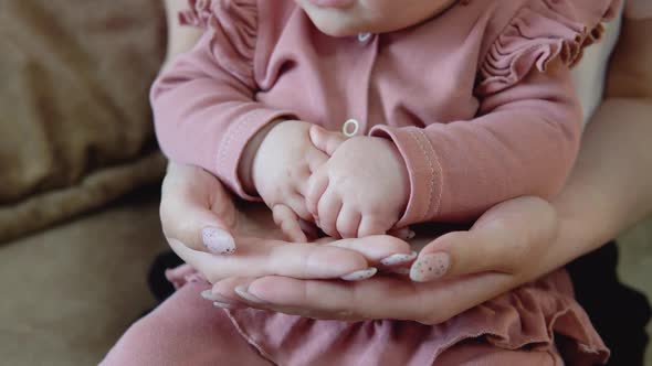 Baby's Hands in Mother's Hands