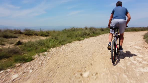 Man On Mountain Bike Windmills In The Background