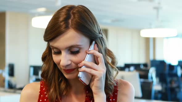 Female executive talking on mobile phone