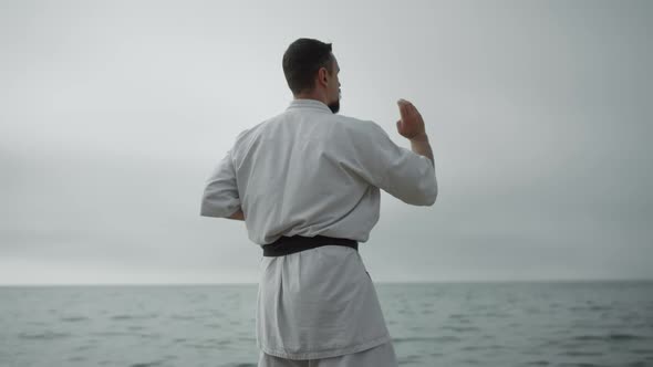 Sportsman Practicing Hand Position Training Karate Near Sea