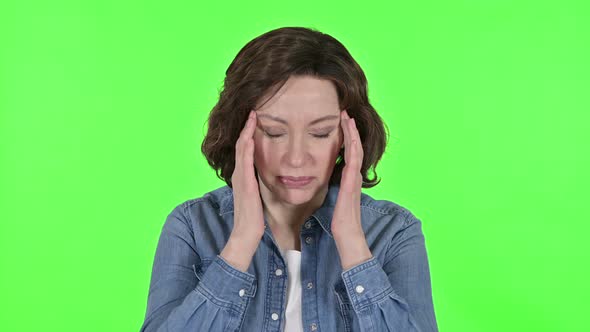 Old Woman Having Headache on Green Chroma Key Background 