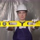 Woman Builder in Blue Overalls and White Hard Hat Helmet with Level - VideoHive Item for Sale