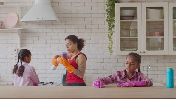 Cute African Girl Cleaning Table with Detergent