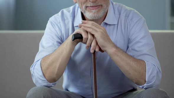 Grandfather Sitting on Couch and Remembering Happy Moments with His Children