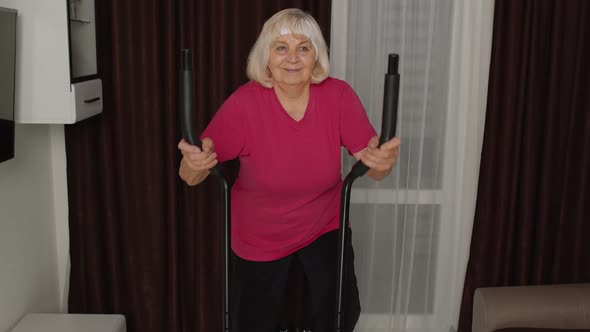 Senior Woman in Sportswear Using Orbitrek in Room at Home Doing Sport Training Cardio Exercises