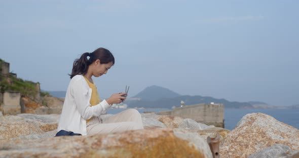 Woman control a drone at the seaside