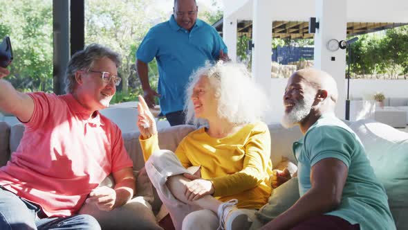 Happy senior diverse people taking selfie at retirement home