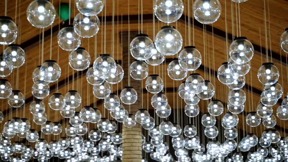 Round transparent bulbs hanging from wooden celling