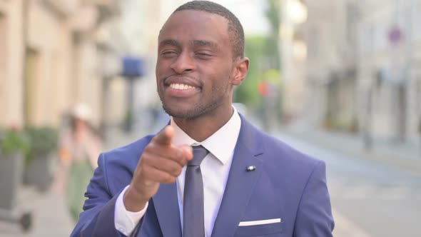 Outdoor African Businessman Pointing at the Camera