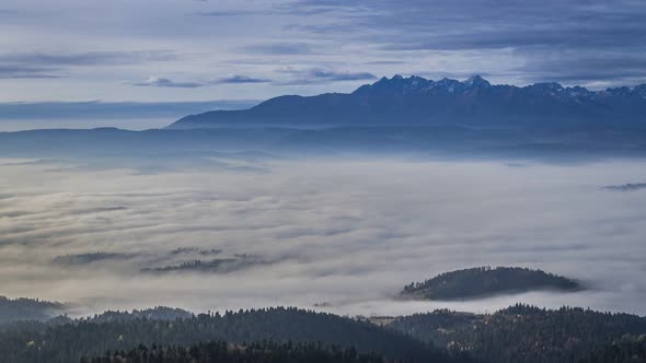 Sunrise in the Tatra mountains with flowing clouds, Poland, Timelapse