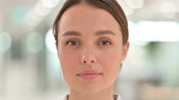 Close Up of Face of Serious Young Woman Looking at the Camera