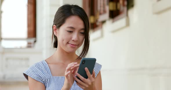 Woman use of mobile phone at the street