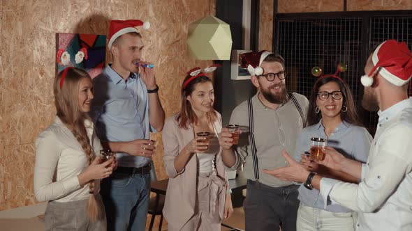 Bearded Man Saying Toast for Friends on Christmas Party Clinking and Drinking