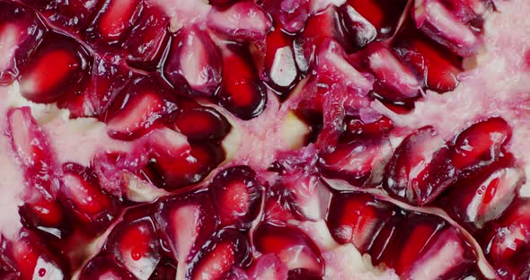 Slice the Pomegranate with Grains Slowly Rotates. 