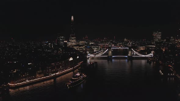 Aerial View to the Illuminated Tower Bridge and Skyline of London at Night UK