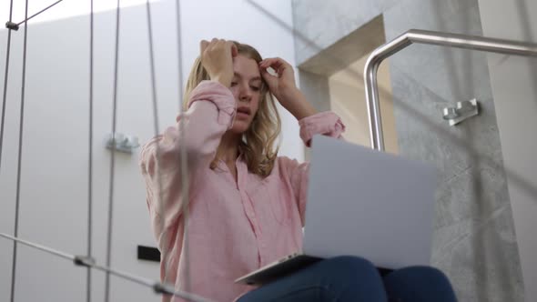 Caucasian woman using laptop in hote