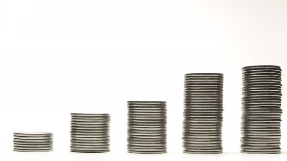 Silver Coins on Stacks Are Decrease on White Background Stop Motion Animation