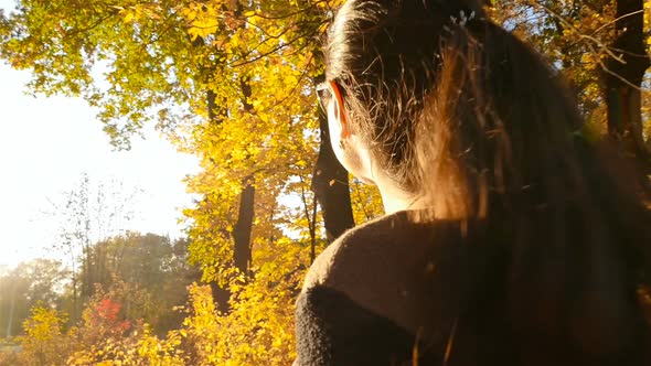 Beautiful Girl Walks in the Autumn Forest