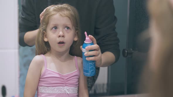 Mommy Irrigates Nose of Scared Girl at Large Mirror