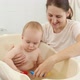 Happy Smiling Mother and Baby Boy Playing with Toy Boats and Ships in Small Plastic Bath - VideoHive Item for Sale