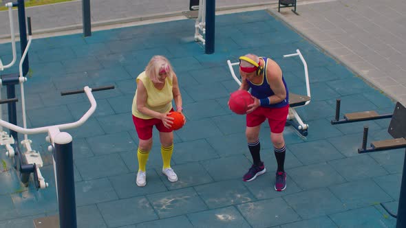 Senior Basketball Team Couple Man Woman Playing Game with Ball Practicing Dribbling at Playground