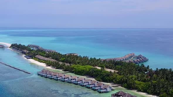 Aerial travel of island beach by lagoon with sand background