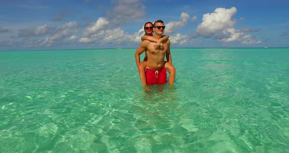 Young man and woman on honeymoon vacation live the dream on beach on summer white sandy background 4