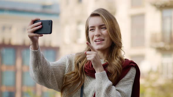 Happy Girl Having Video Call By Phone Outdoors. Cheerful Woman Using Phone