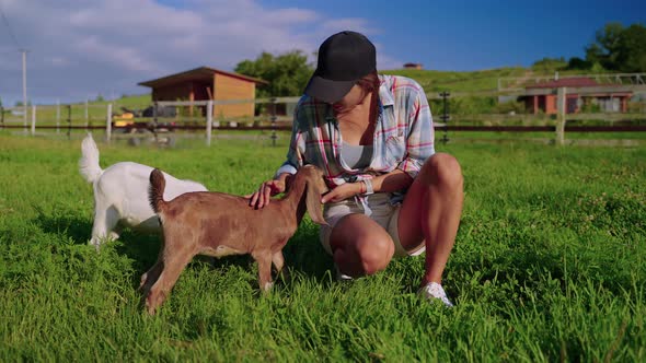 Girl with Goats on the Farm