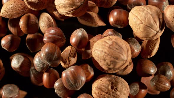 Super Slow Motion Shot of Flying Mix of Whole Nuts Towards Camera Isolated on Black at 1000Fps