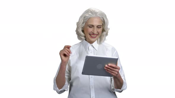 Happy Mature Woman Using Digital Tablet