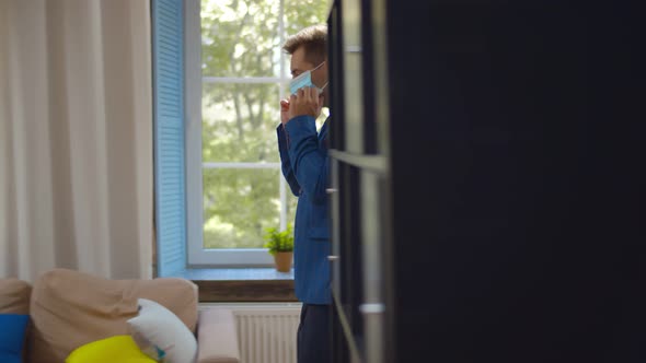 Side View of Young Businessman Putting on Protective Mask and Going To Work