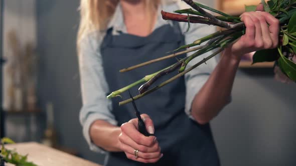 Professional Female Floral Artistpreparing a Bouquet Florist Cutting Flower Stems at Flower Shop