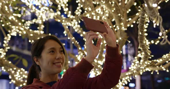 Woman Look at The Christmas Tree Decoration at Night