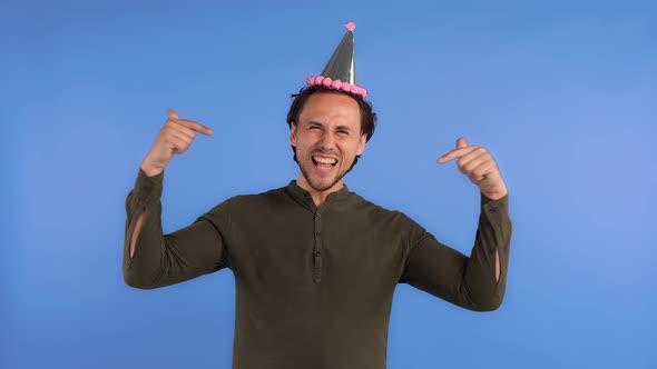 Guy in Party Hat and Khaki Colored Shirt