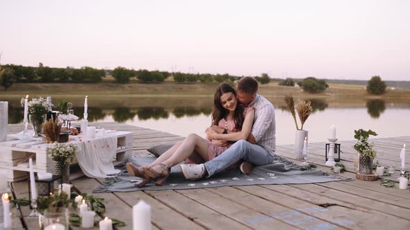 Romantic Couple. Young Man Embracing His Girlfriend From Behind and Kissing Her