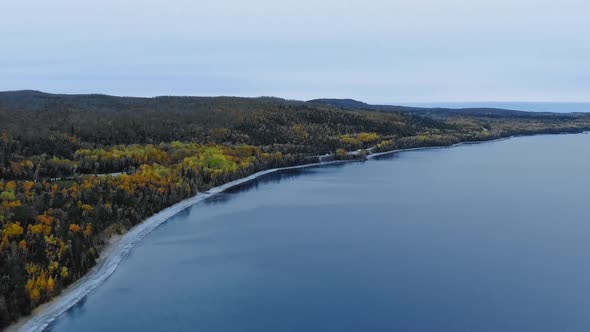 Drone hovers over the coastline of Alona Bay, Lake Superior, Ontario, Canada