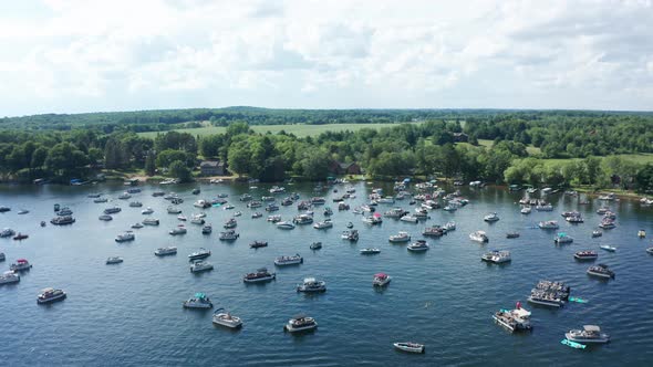 Aerial, lake crowded with party motor boats during college spring summer break